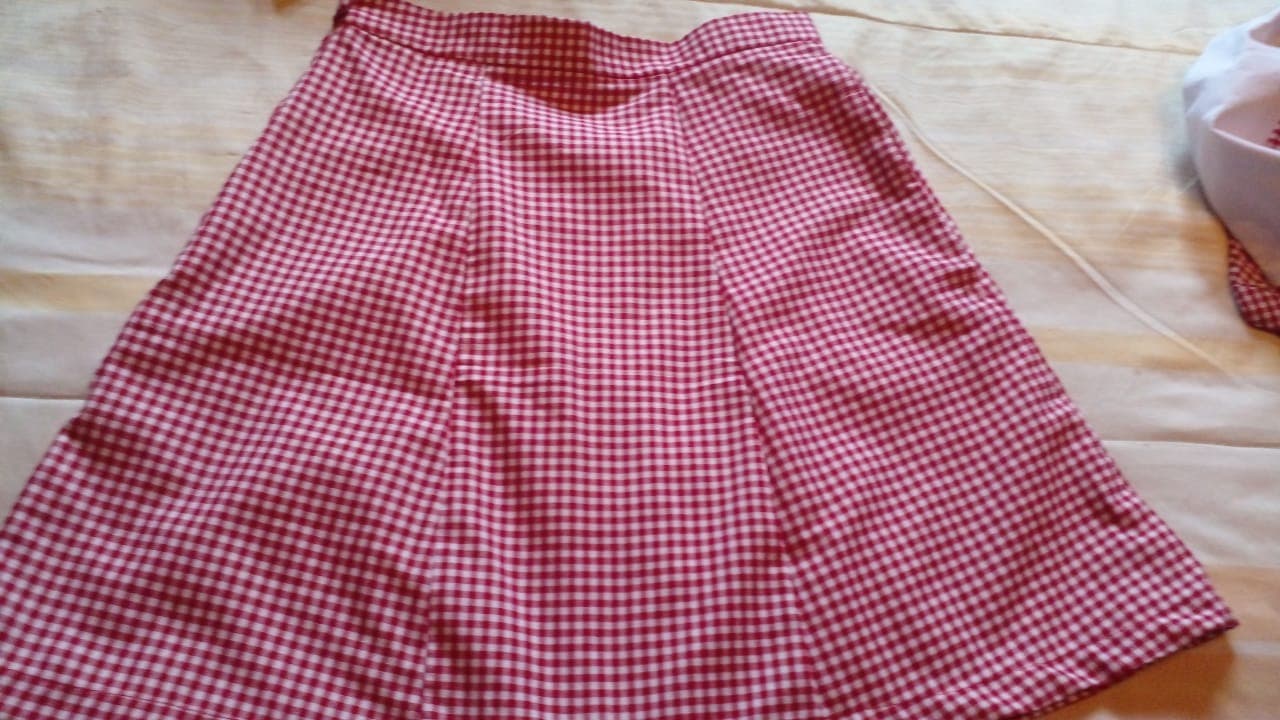A handmade gingham skirt laid out during production