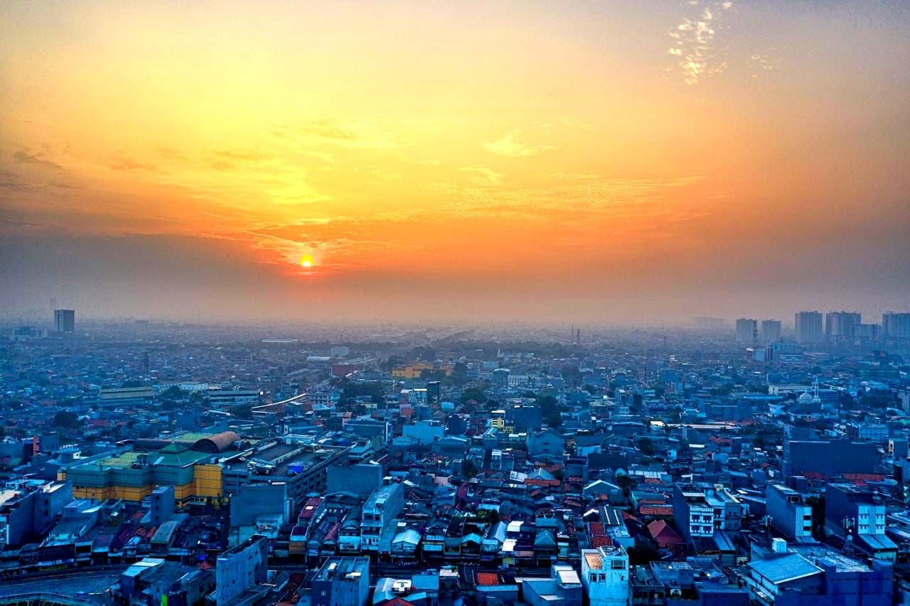 Wide city skyline at sunset